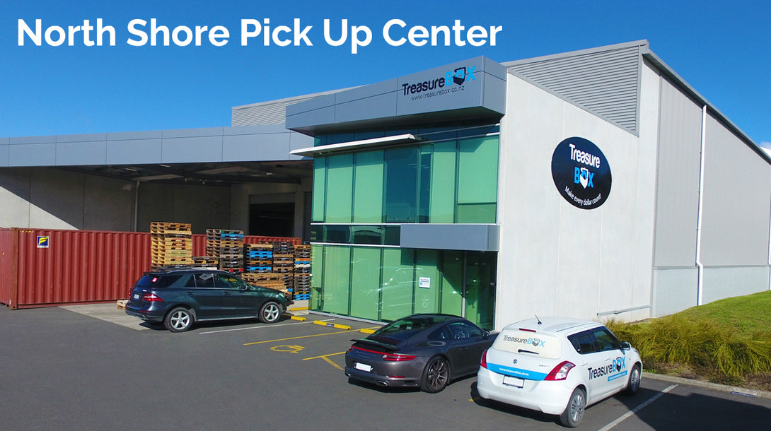 North Shore Pick Up Center exterior view with vehicles parked and pallets stacked outside.