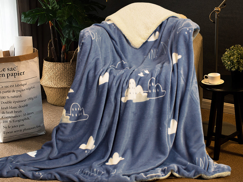 Cozy double layer fleece blanket throw with cloud pattern, perfect for snuggling on the couch or during winter travels.
