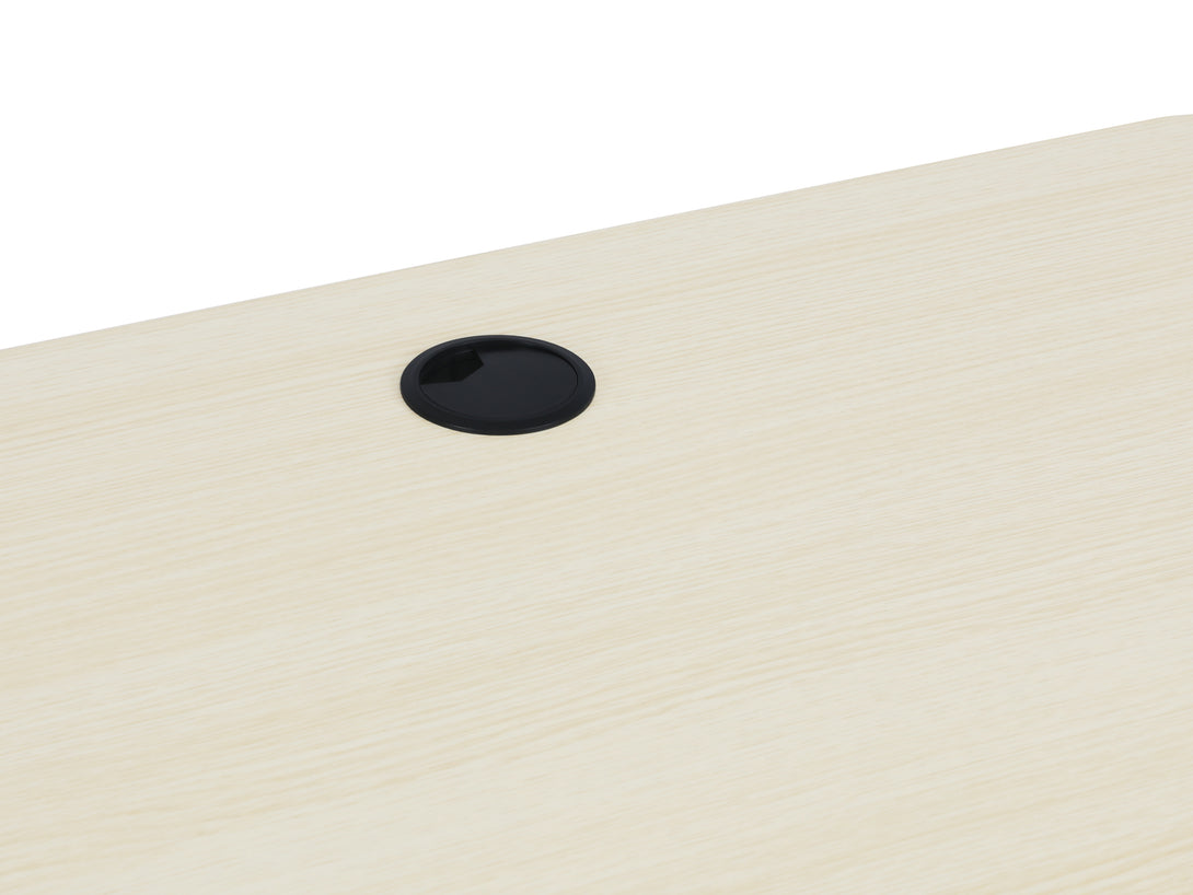Close-up of beige electric standing desk surface featuring a cable management hole.