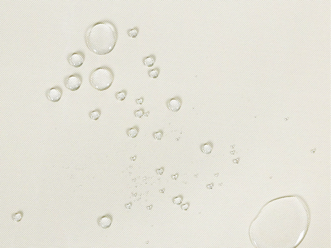 Close-up of water droplets on a beige fabric surface, highlighting water-resistant properties.