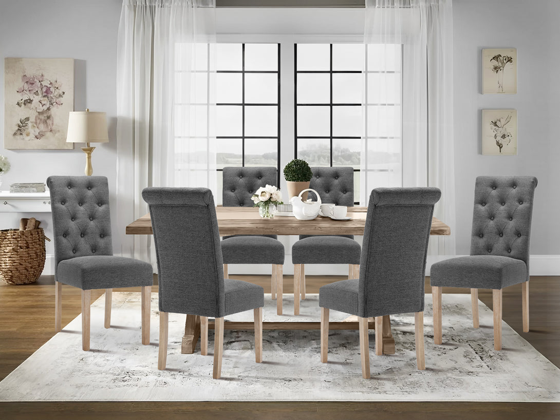 Stylish Zoey 6 piece upholstered dining chairs in dark grey around a wooden dining table in a bright room.
