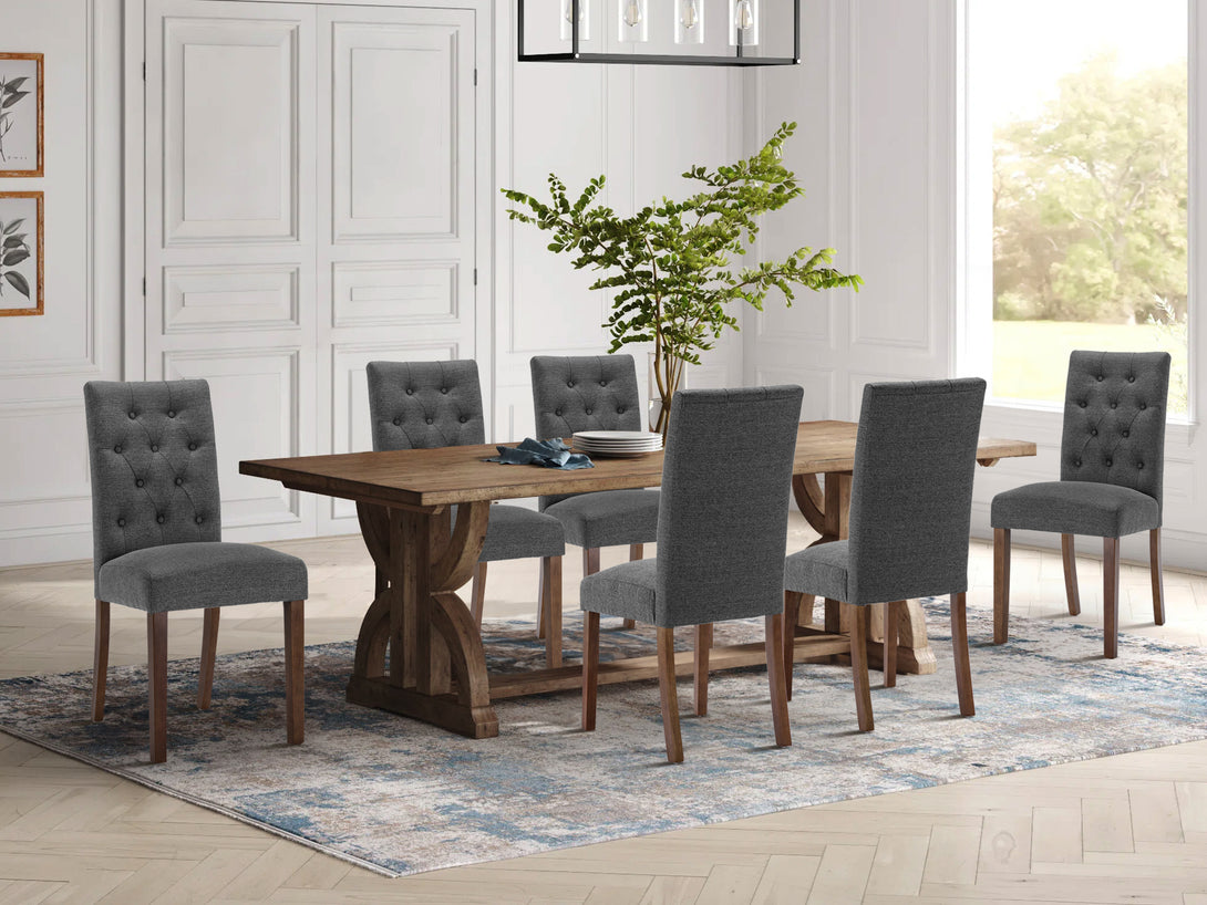 Lucia 6 Piece Upholstered Dining Chair set in Dark Grey around a wooden dining table with decorative elements.