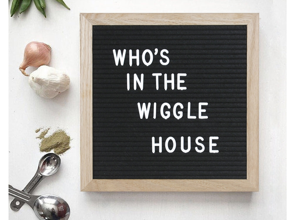 Changeable DIY felt letter board with text 'Who's in the Wiggle House', ideal for home decor and photo props.