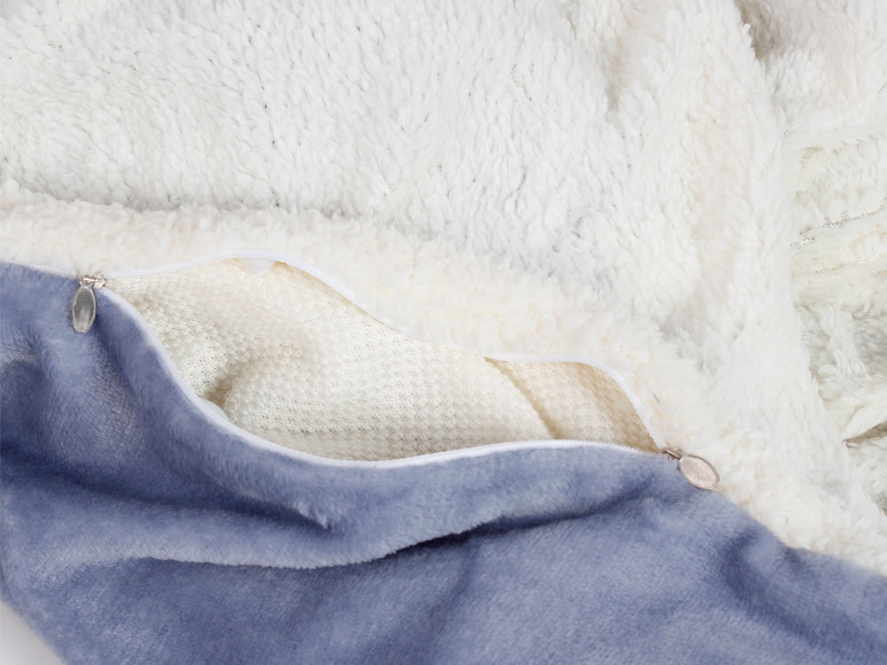 Close-up of double layer fleece blanket throw with soft textures in cream and blue, showcasing zipper detail.