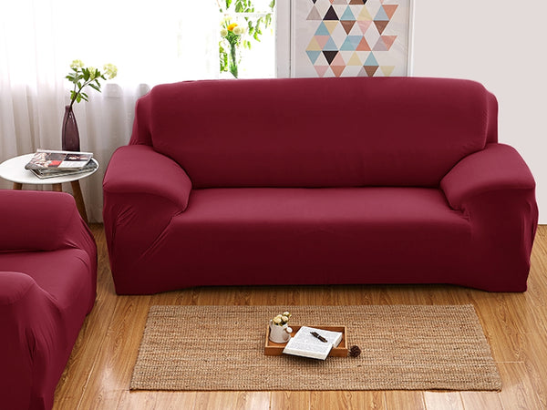 Red elastic couch cover for 2-seater sofa, providing a fresh look and protection for old furniture in any living space.