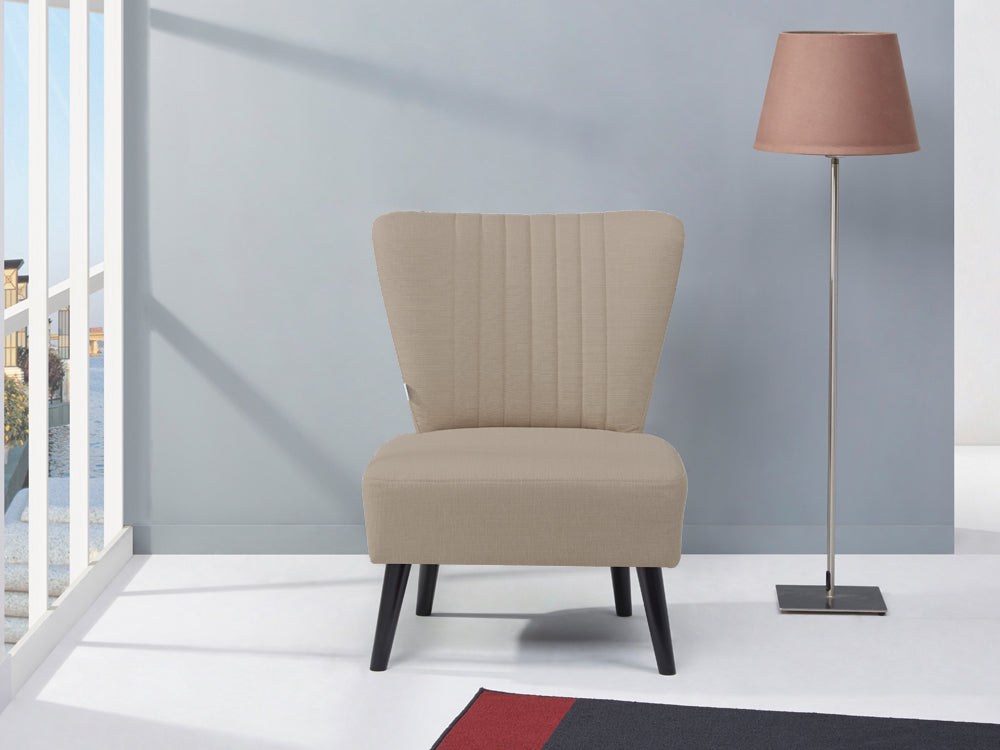 Anita Occasional Chair by BetaLife in beige fabric, set in a stylish room with a floor lamp.